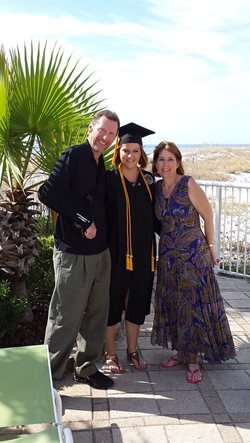 Doug Rowland hugs his daughter Amber from her right as Tracy Rowland hugs her from the left