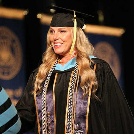 Smiling woman in graduation cap and gown
