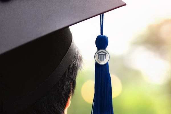 Close up of a CSU branded tassle hanging from a graduation cap.