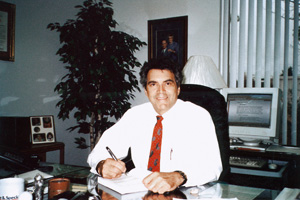 Dr. Robert G. Mayes, Sr. sitting at his desk