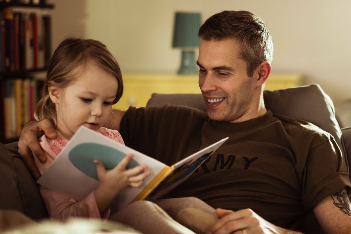 veteran reads with a young child