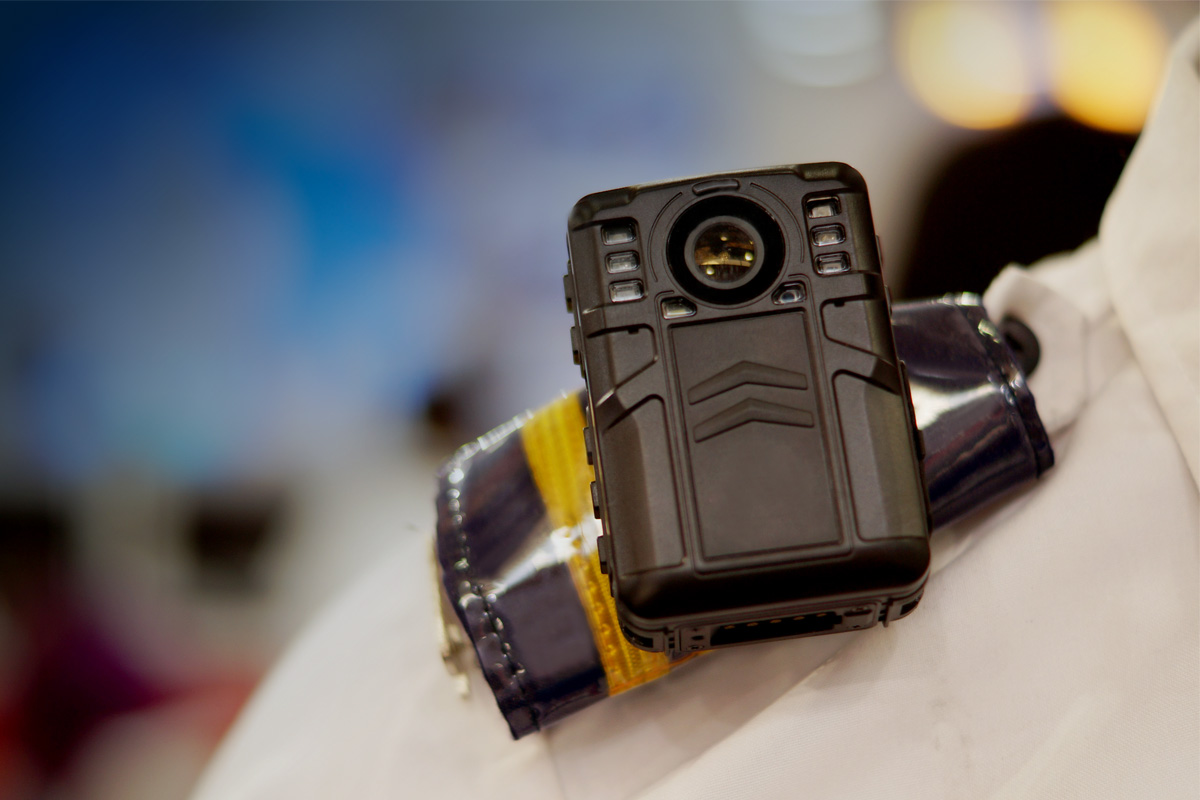 Close up shot of body camera being worn on a law enforcement officer's shoulder