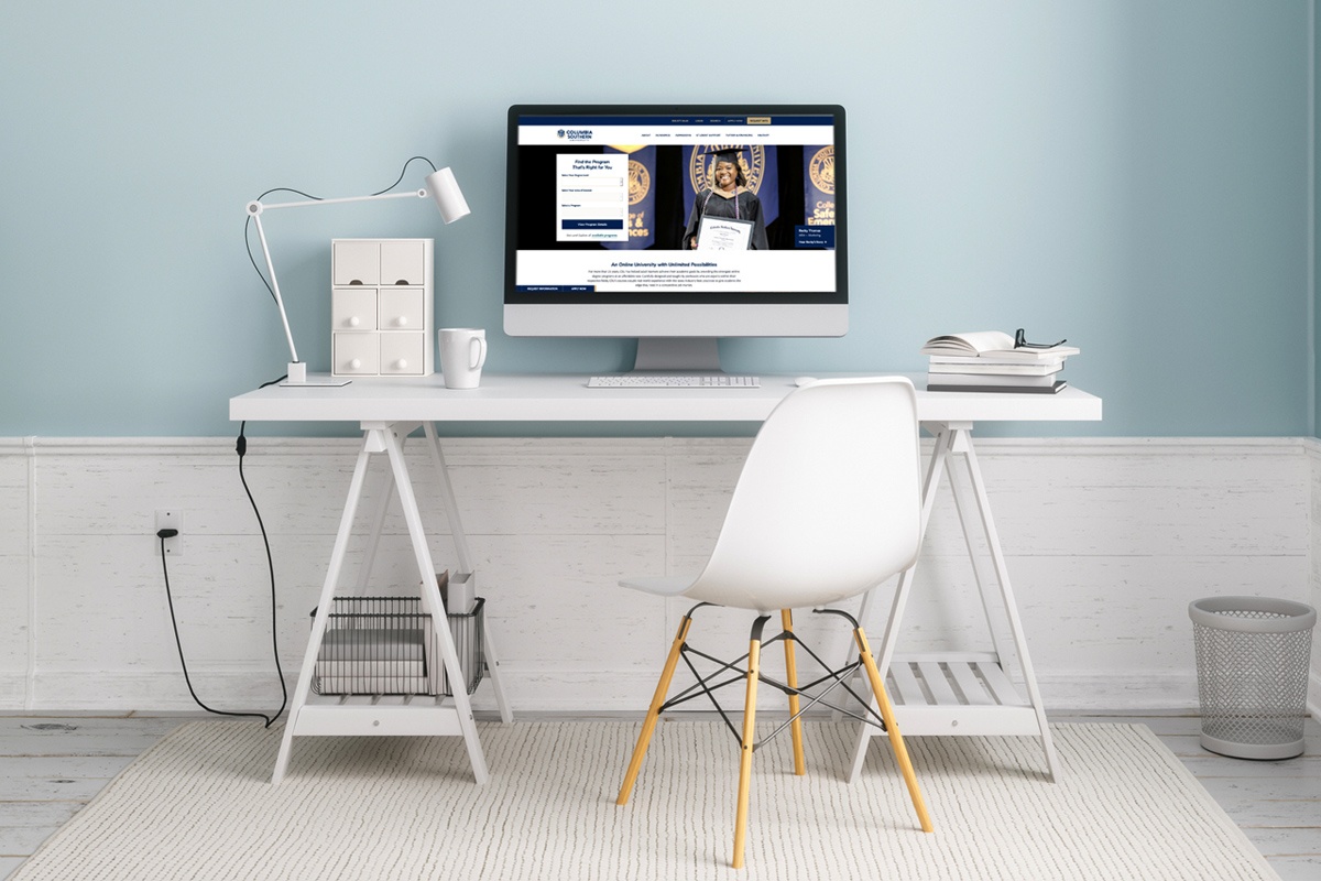 A home office desk with a computer showing the CSU homepage.