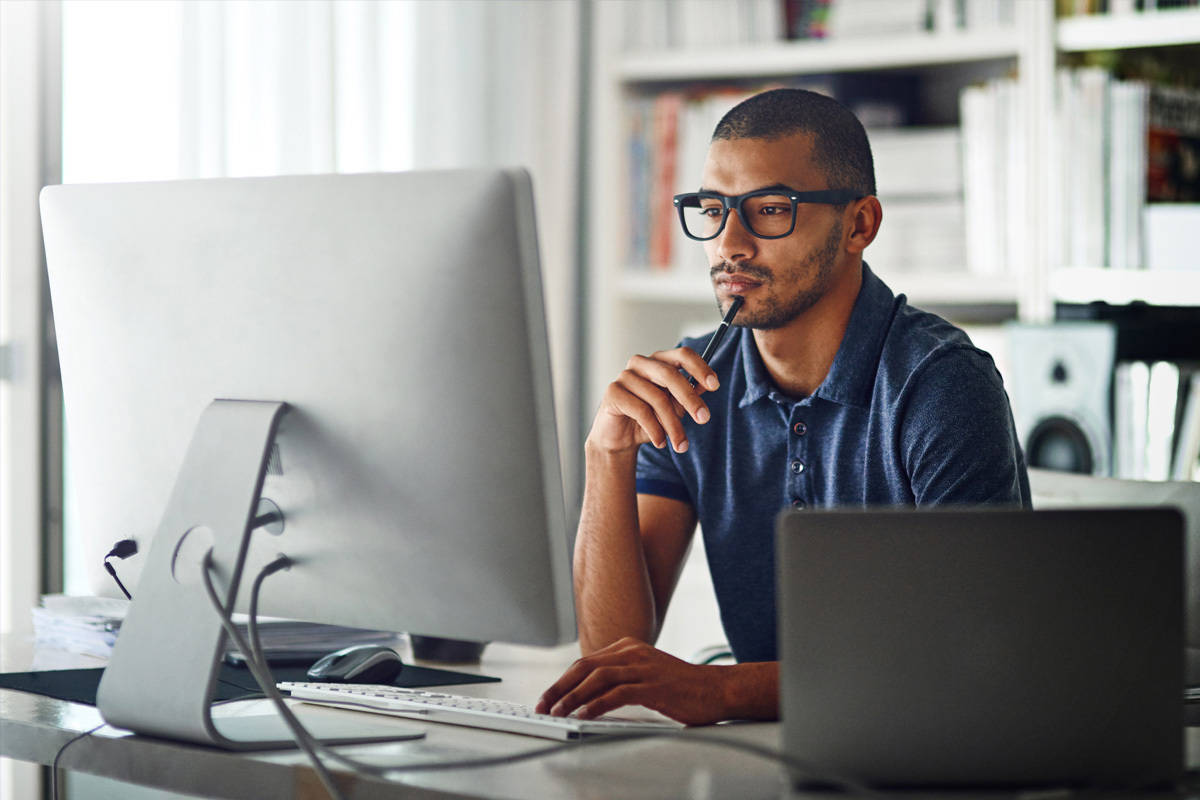 Military veteran sitting at a desk and looking at a computer screen