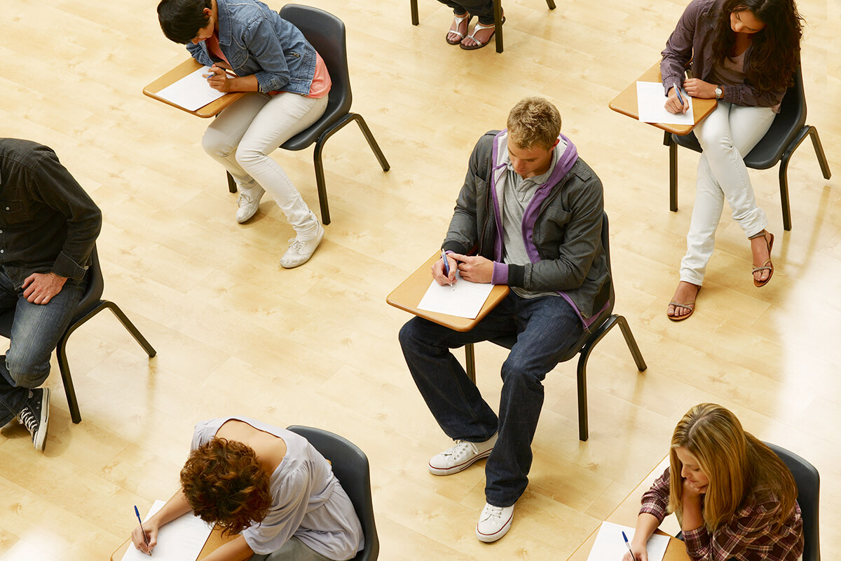 Overhead view of college students taking an exam.