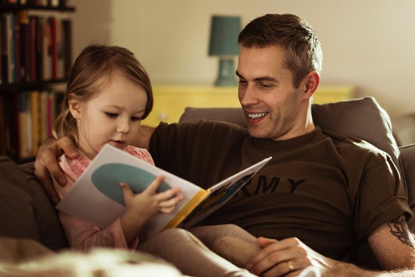 veteran reads with a young child