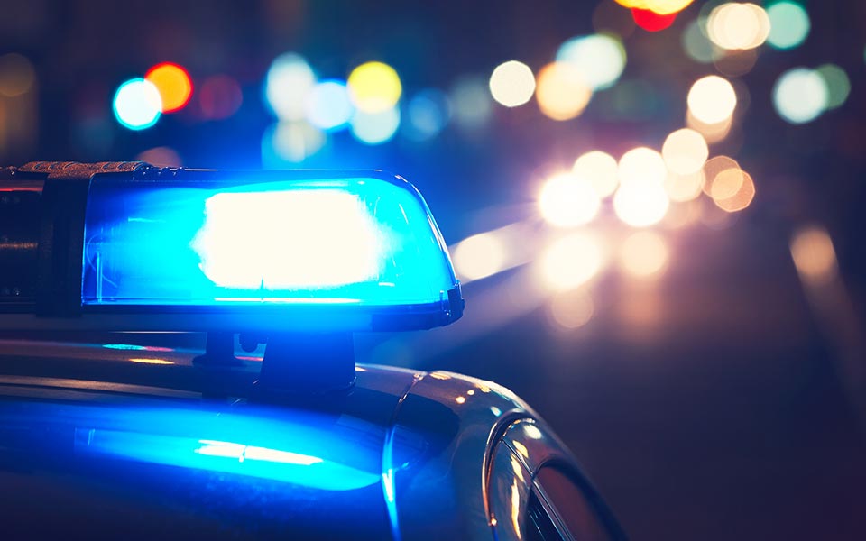 Close up of blue light atop police car at night