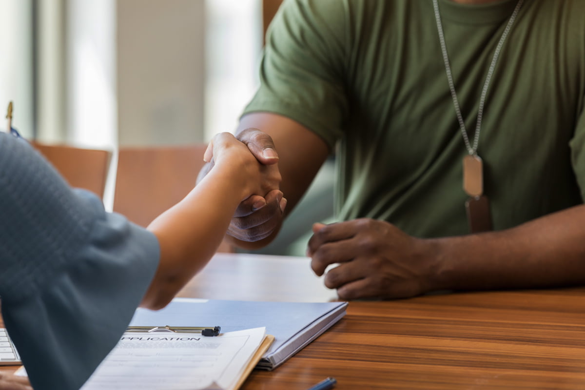 military service member shaking hands and discussing transition resources