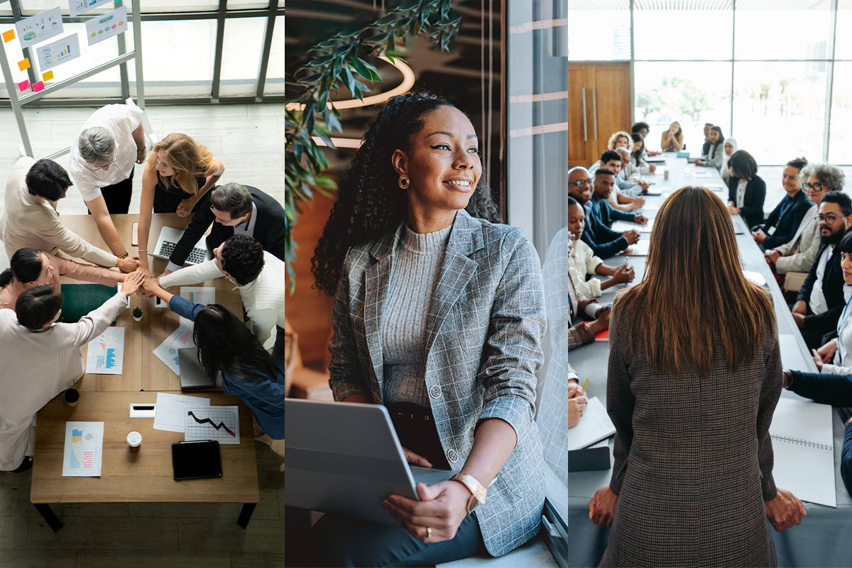 A man in a business suit smiles down at his laptop