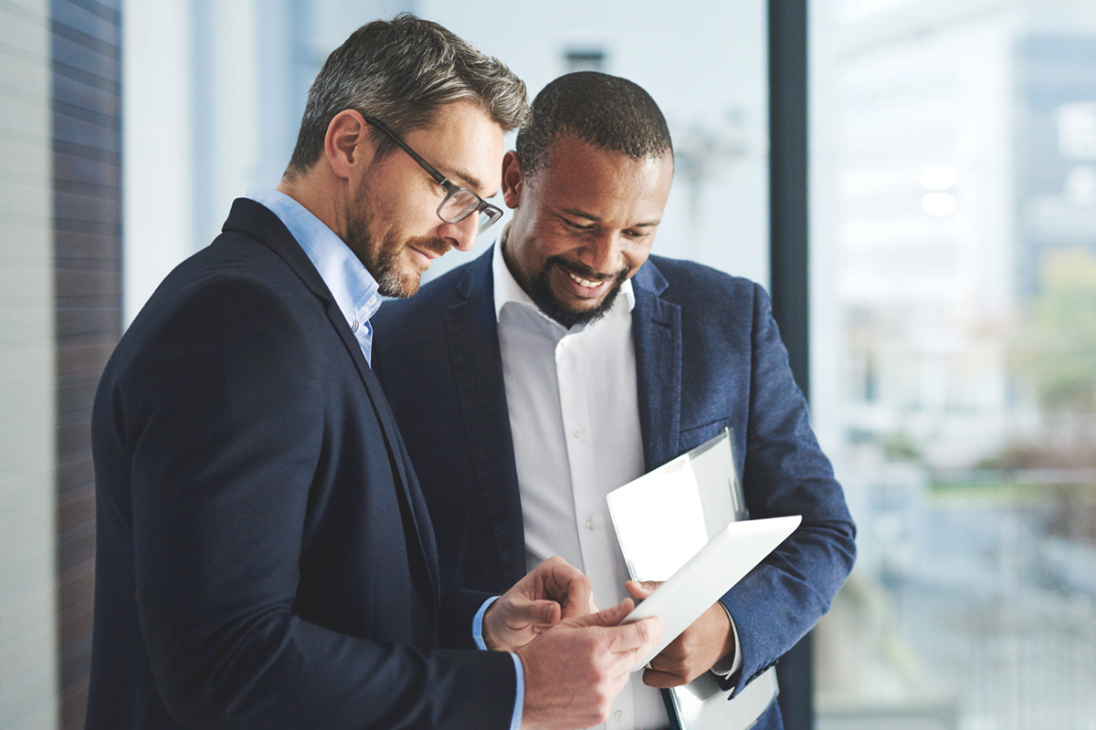 public administration consultant standing with client and reviewing information