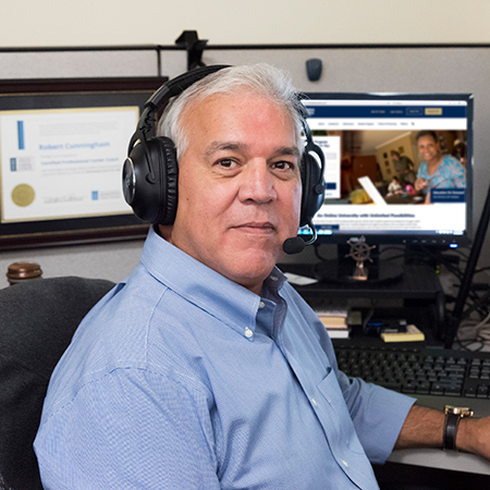 CSU staffer wearing a headset assisting prospective students 