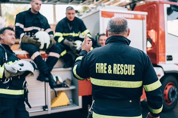 Fire & Rescue leader speaks to a group of fire fighters.