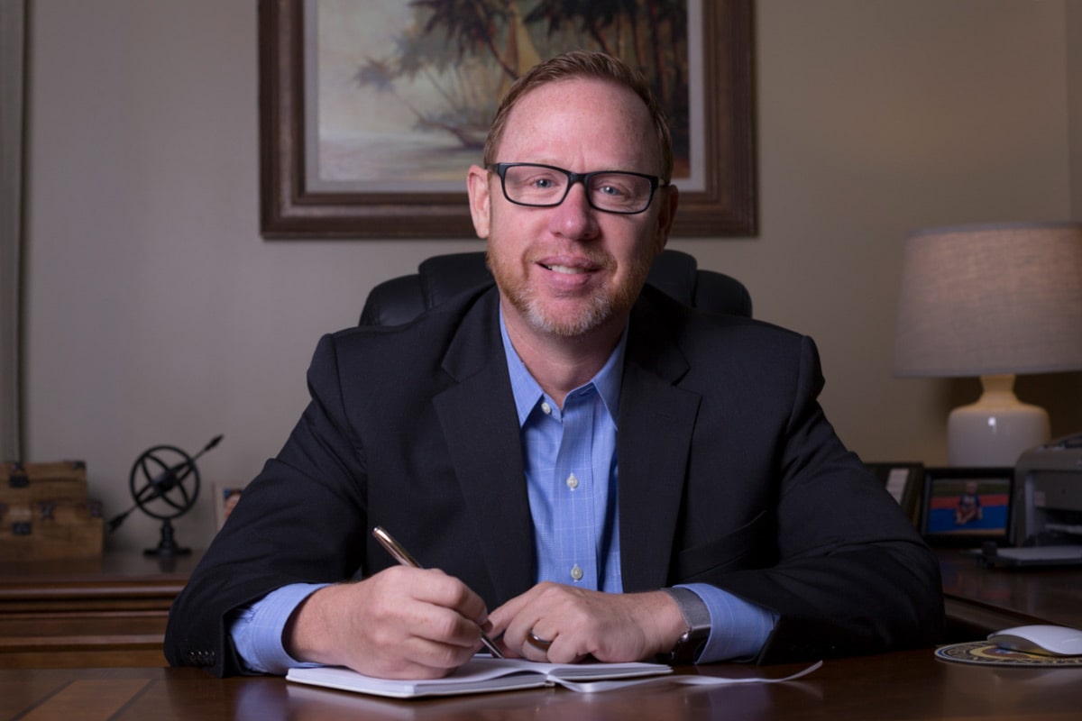 Eric McHaney sitting at desk.