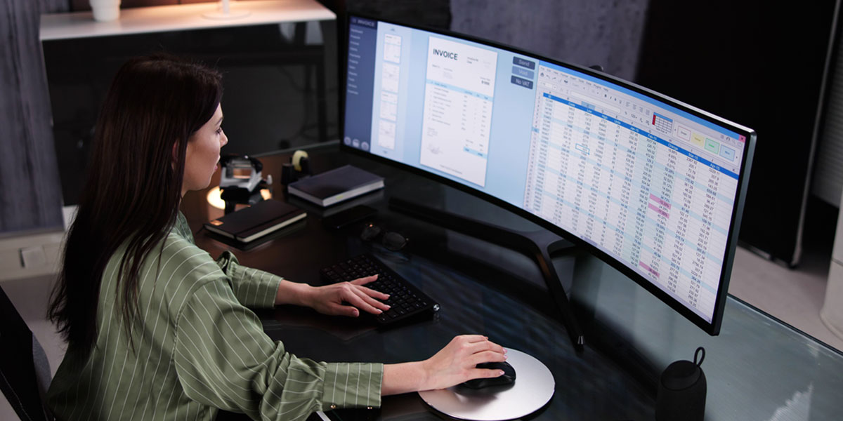 military spouse sitting at desk and using a computer at their job