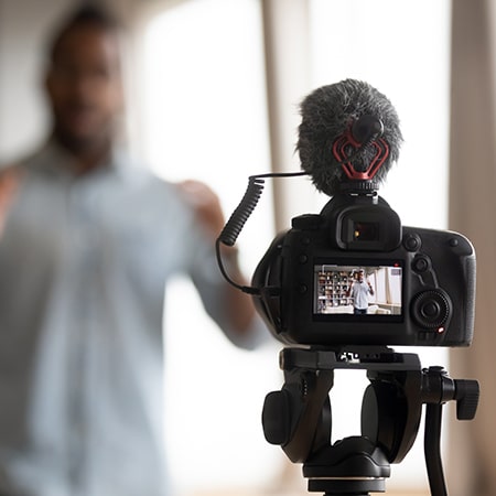 video camera with student in the background