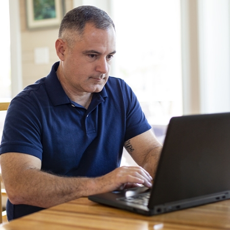 Old man working on a laptop