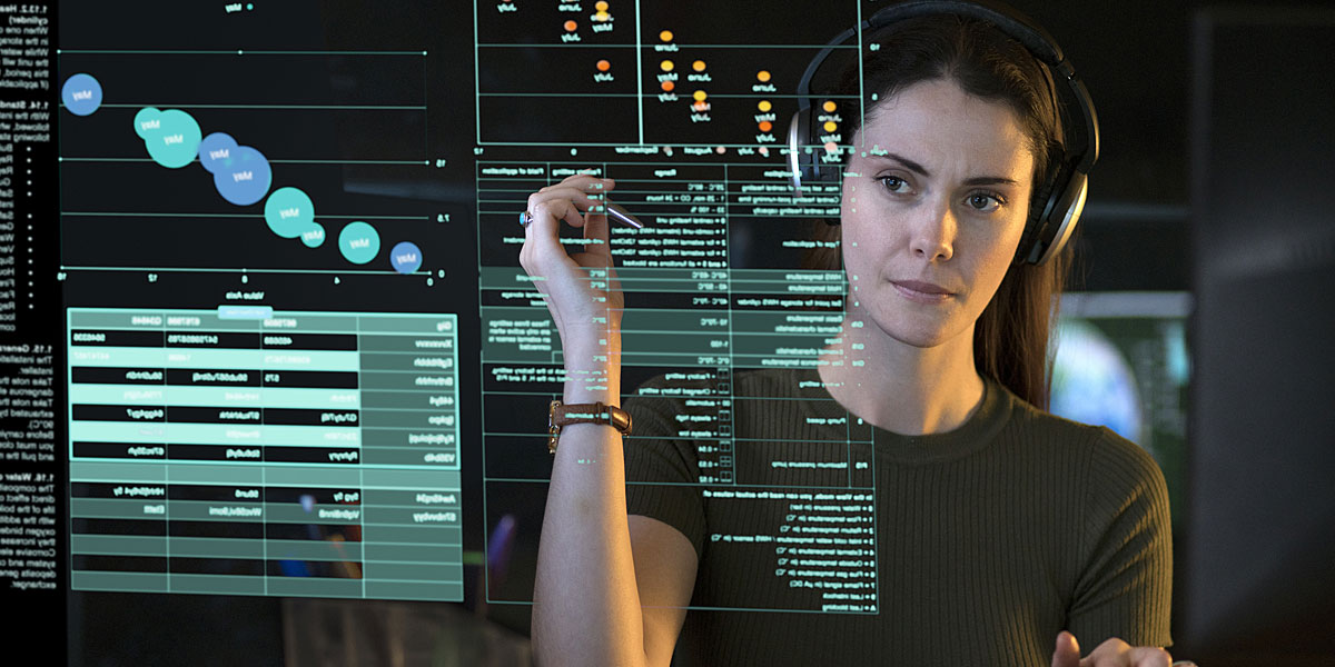 military intelligence officer standing in front of a screen and reviewing data