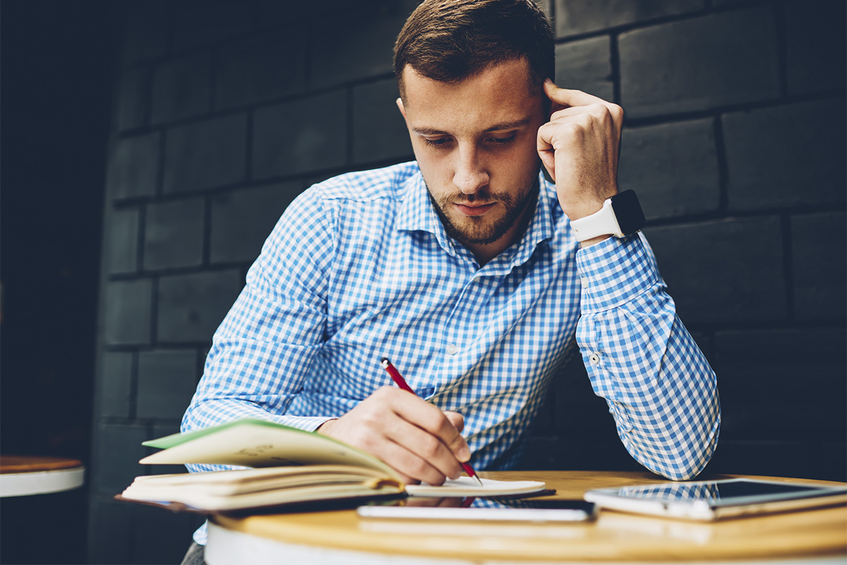 military service member sitting at desk and writing