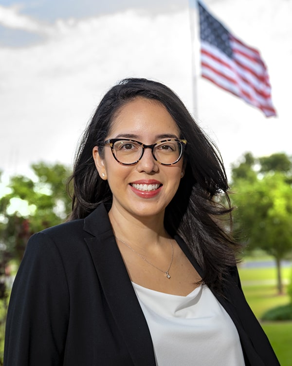 Cindy P. Chiribao next to American Flag