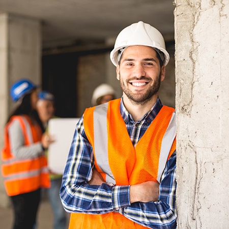 man with hard hat and orange vest